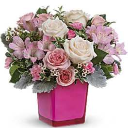 Pink and white roses with pink alstroemeria in a bright pink vase