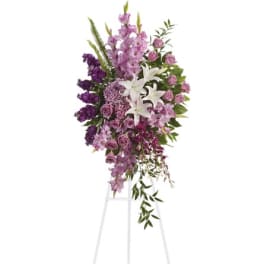 Tall purple and white floral standing spray on an easel