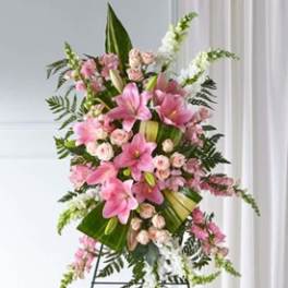 Tall pink lily and rose standing spray on an easel