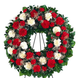 Red and white carnation wreath on a standing easel