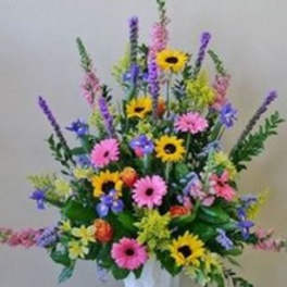 Colorful mixed flower arrangement in a white vase