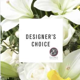 White lilies and roses around a designer's choice card