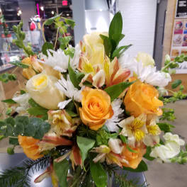 Bouquet of orange and white flowers in a clear glass vase