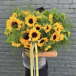 Large bouquet of yellow sunflowers with a ribbon tie