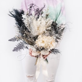 Bouquet of white dried flowers with black foliage and a cream ribbon