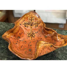 Orange ceramic decorative bowl with a cross design
