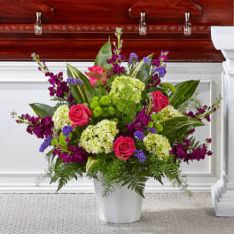 Pink roses and purple flowers in a white vase