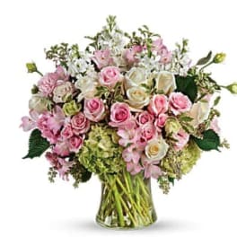 Pink and white rose bouquet in a clear glass vase