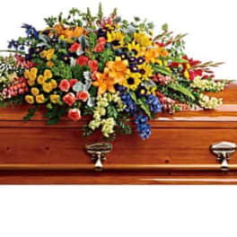 Colorful floral spray on a wooden casket