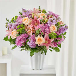 Pink and lavender mixed bouquet in a white vase
