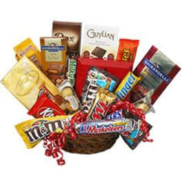 Basket of assorted candy bars and chocolate packages with red ribbon