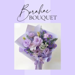 Lavender bouquet with purple and white flowers wrapped in lilac paper