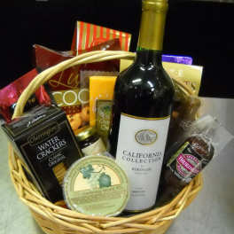 Gift basket with wine, crackers, cheese, and chocolates