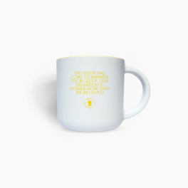 White mug with yellow text and a small logo