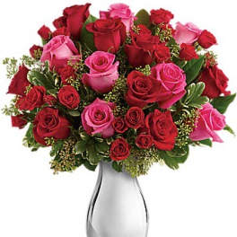 Bouquet of red and pink roses in a silver vase