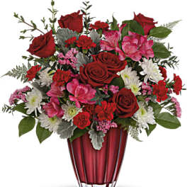 Red and pink mixed bouquet in a red vase