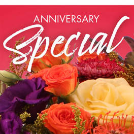 Mixed bouquet of roses and purple blooms with an anniversary card