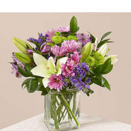 Mixed pink and purple flowers in a clear glass vase