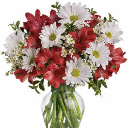 Red and white mixed bouquet in a clear glass vase