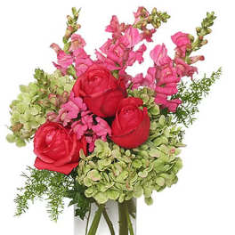Pink and red flowers arranged in a clear glass vase
