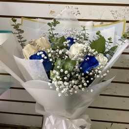 Bouquet of white and blue roses with baby's breath and eucalyptus in white wrap