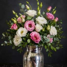 Pink and white lisianthus bouquet in a silver vase