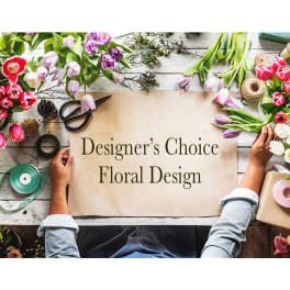 Designer’s Choice Floral Design sign surrounded by tulips and floral tools