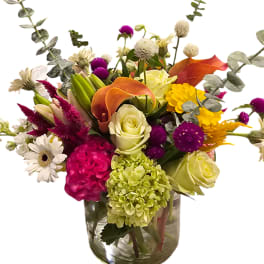 Colorful mixed bouquet in a clear glass vase