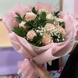 Pink rose bouquet wrapped in pastel pink paper