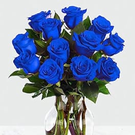 Bouquet of blue roses in a clear glass vase