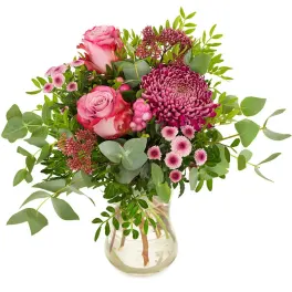 Pink roses and magenta chrysanthemums in a clear glass vase