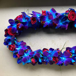 Oval floral wreath of blue-purple orchids and red roses