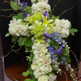 Tall floral arrangement with white, green, and purple blooms