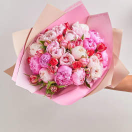 Pink and white peony bouquet wrapped in pastel paper