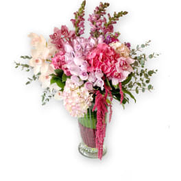 Pink and white floral arrangement in a clear glass vase