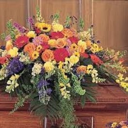Large colorful floral casket spray with mixed blooms