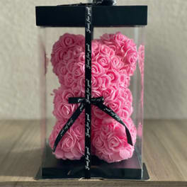 Pink rose teddy bear in a clear gift box with black ribbon