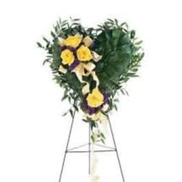 Heart-shaped floral spray on a standing easel with yellow roses