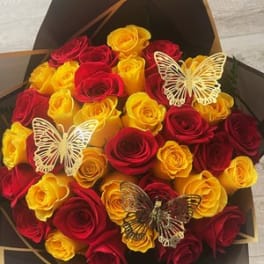 Bouquet of red and yellow roses with butterfly decorations
