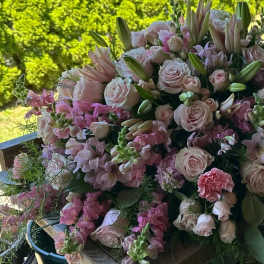 Large bouquet of pale pink roses and lilies with pink filler flowers