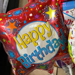 Red birthday balloon with colorful stars and "Happy Birthday" text