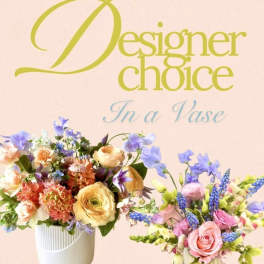 Two colorful flower arrangements in white vases against a pink background