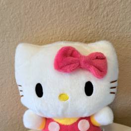 Hello Kitty plush toy with a pink bow and outfit