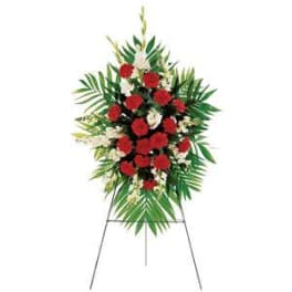 Standing floral spray with red and white flowers on an easel