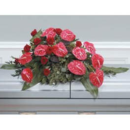 Red floral casket spray with anthuriums and roses