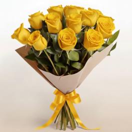 Bouquet of yellow roses wrapped in paper with a yellow ribbon