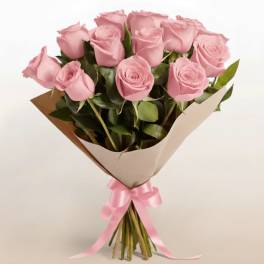 Bouquet of pink roses wrapped in brown paper with a pink ribbon