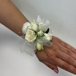 White rose wrist corsage with sheer ribbon and rhinestone accents