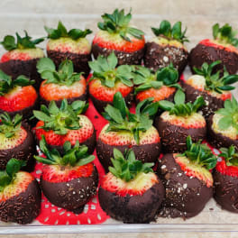 Chocolate-dipped strawberries in a clear plastic tray
