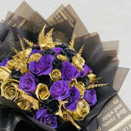 Bouquet of purple, black, and gold roses wrapped in dark paper
